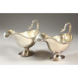 A GOOD PAIR OF CONTINENTAL SILVER SAUCEBOATS with scrolling bird handles. Weight 20ozs.