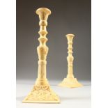 A PAIR OF DECORATIVE BONE CANDLESTICKS. 24cms high.