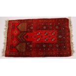 A PERSIAN PRAYER RUG, claret ground with stylized decoration. 120cms x 75cms.