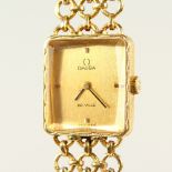 A LADIES' 18CT GOLD OMEGA DE VILLE WRISTWATCH with bracelet strap.