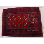 A PERSIAN PRAYER RUG, red ground with stylized gull motifs. 125cms x 95cms.