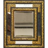 A 19TH CENTURY CONTINENTAL EBONISED MIRROR, with mirrored slips and embossed gilt metal mounts.