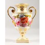 A CROWN DERBY TWO HANDLED URN with gilt decoration, painted with flowers. Mark in red. 28cms high.