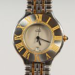 A GOOD CARTIER STEEL AND GOLD WRISTWATCH, with yellow numbers, in a red box.