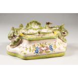 A MAJOLICA INKSTAND with two inkwells and dolphins. 23cms long.