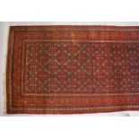 A PERSIAN LONG CARPET, blue ground with stylized geometric motifs, with a similar border. 500cms x