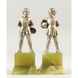JOSEPH LORENZL. THE YOUNG TENNIS BOY AND GIRL. Silvered bronze on an onyx base. Signed on foot. R.