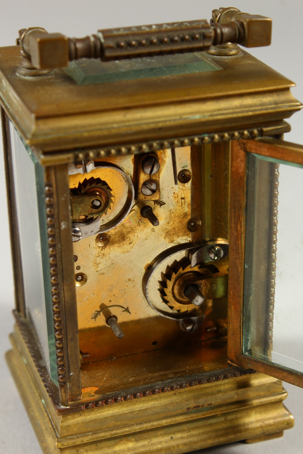 A MINIATURE BRASS CARRIAGE CLOCK, with alarm and subsidiary dial. 12cms high. - Image 7 of 7