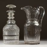 A GEORGIAN LEAD JUG AND CUT GLASS DECANTER AND STOPPER.