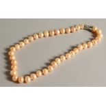 A LARGE PINK PEARL NECKLACE with magnetic clasp. 47cms long.