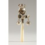 A SILVER TEDDY BEAR RATTLE, with mother-of-pearl handle. 9.5cms long.