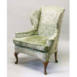 A GEORGE III DESIGN WING ARMCHAIR, with plain cabriole legs to the front and back. 118cms high x