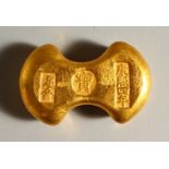 A CHINESE GOLD COLOUR INGOT STYLE WEIGHT. 6cms wide.