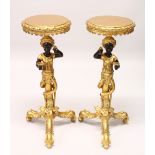 A PAIR OF DECORATIVE GILDED BLACKAMOOR TRIPOD STANDS. 96cms high.