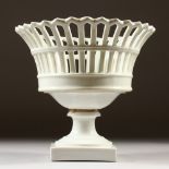 A FRENCH WHITE PIERCED PORCELAIN PEDESTAL BASKET. 20cms high.