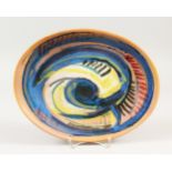QUENTIN BELL (FULHAM POTTERY). AN OVAL DISH with blue and yellow scrolls. Signed on reverse. 33cms