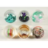 SIX VARIOUS SIGNED GLASS PAPERWEIGHTS.