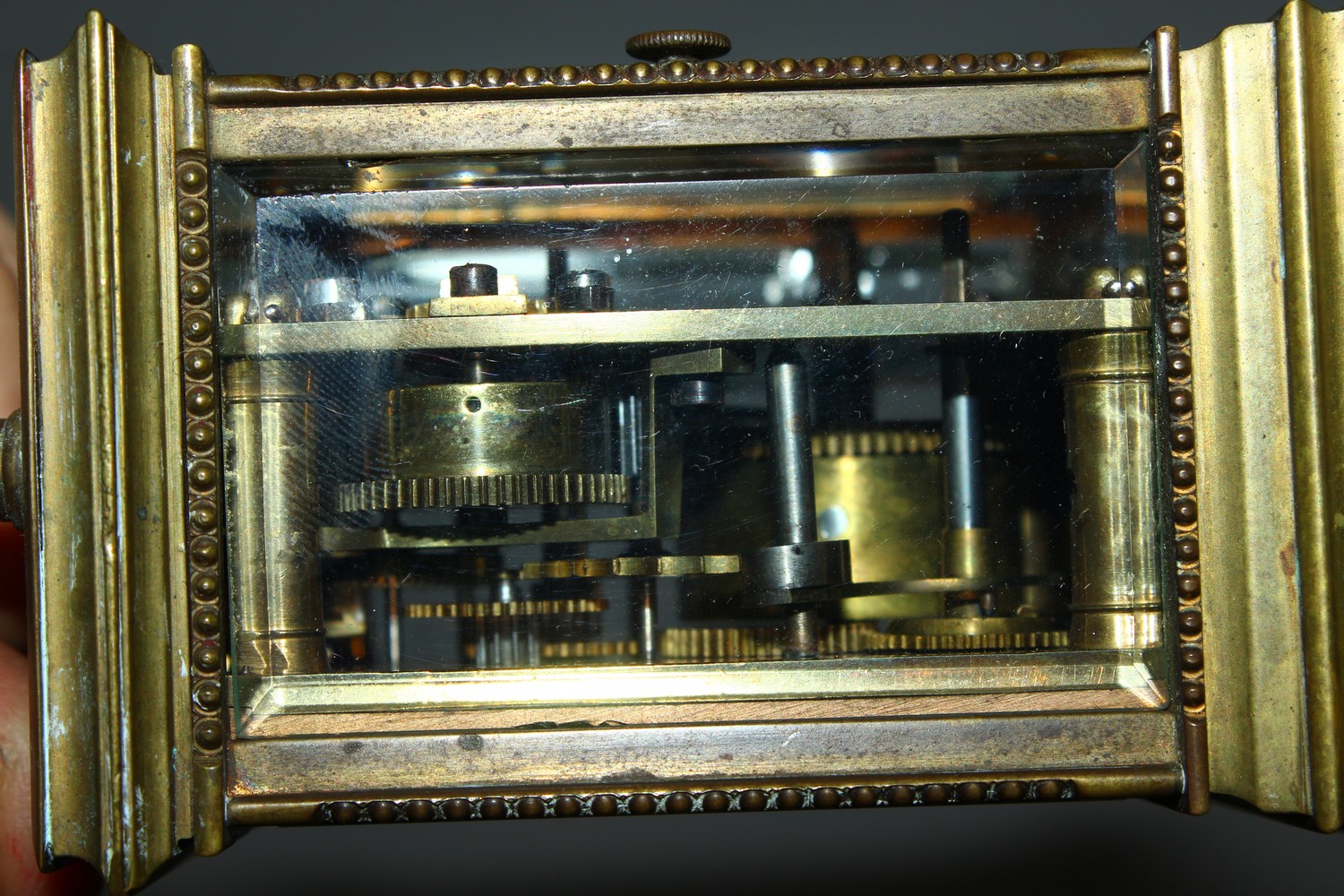 A MINIATURE BRASS CARRIAGE CLOCK, with alarm and subsidiary dial. 12cms high. - Image 4 of 7