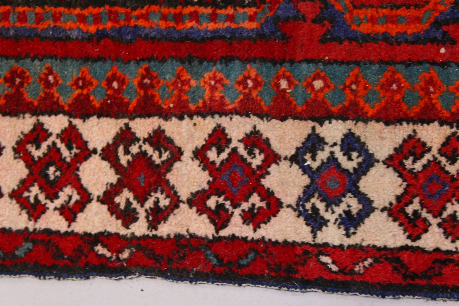 A PERSIAN LONG CARPET / RUNNER, bright red ground with three blue ground motifs in a stylized - Image 2 of 8