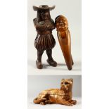 A CARVED WOOD DOG INKWELL, NUT CRACKER AND STANDING WOODEN FIGURE