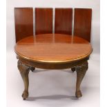 A VICTORIAN MAHOGANY EXTENDING DINING TABLE, of rounded form, with heavy, carved cabriole legs, claw