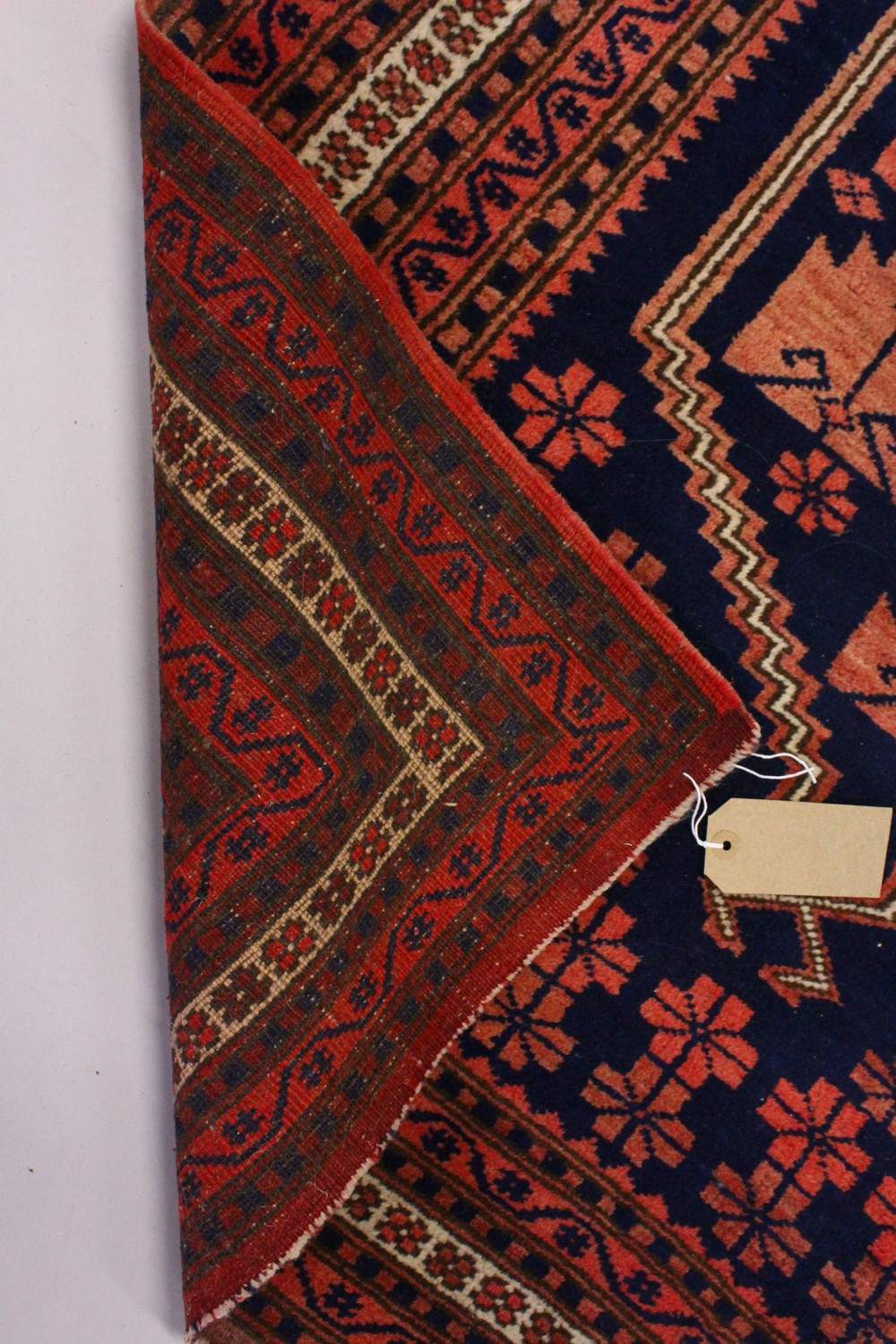 A PERSIAN RUG, dark blue ground, geometric motifs in a multiple border. 195cms x 110cms. - Image 7 of 8