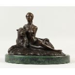 A BRONZE FIGURE OFM A FEMAL NUDE, reclining beside a panther, on a marble base. 30cms wide.