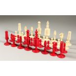 A RED AND WHITE STAINED IVORY CHESS SET.