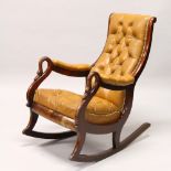 A 19TH CENTURY MAHOGANY AND LEATHER UPHOLSTERED ROCKING CHAIR, the arms with swan neck terminals,