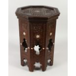 AN ISLAMIC CARVED OCTAGONAL TABLE, inlaid with bone.
