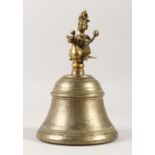 A GOOD INDIAN METAL AND BRASS TEMPLE BELLS, the handle as a figure riding a bird. 25cms high.