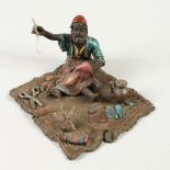 A VIENNA STYLE BRONZE modelled as a carpet repairer. 12cms wide.