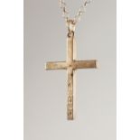 A SILVER CROSS, on a chain.
