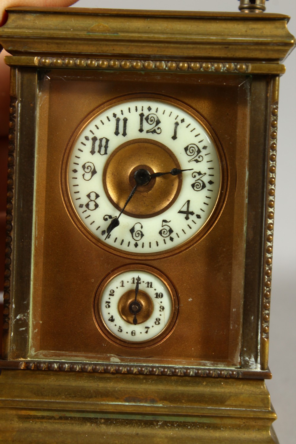A MINIATURE BRASS CARRIAGE CLOCK, with alarm and subsidiary dial. 12cms high. - Image 2 of 7