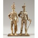 A PAIR OF CAST SILVER MODELS OF SOLDIERS. 10.5cms high.