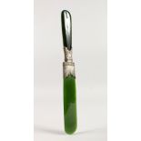 A SILVER MOUNTED JADE PAPER KNIFE. 23cms long.