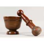 A TURNED FRUITWOOD PESTLE AND MORTAR.
