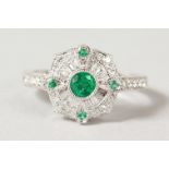 AN 18CT WHITE GOLD DECO STYLE DIAMOND AND EMERALD RING.