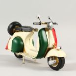 A TIN VESPA, painted in red and cream. 29cms long.