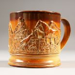 A 19TH CENTURY SALT GLAZE FROG MUG, the side with a fox hunting scene. 10cms high.