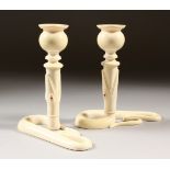 A PAIR OF CEYLONESE IVORY CANDLESTICKS, circa 1900. 15cms high.