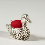 A SILVER DUCK SHAPE PIN CUSHION. 3.5cms long.