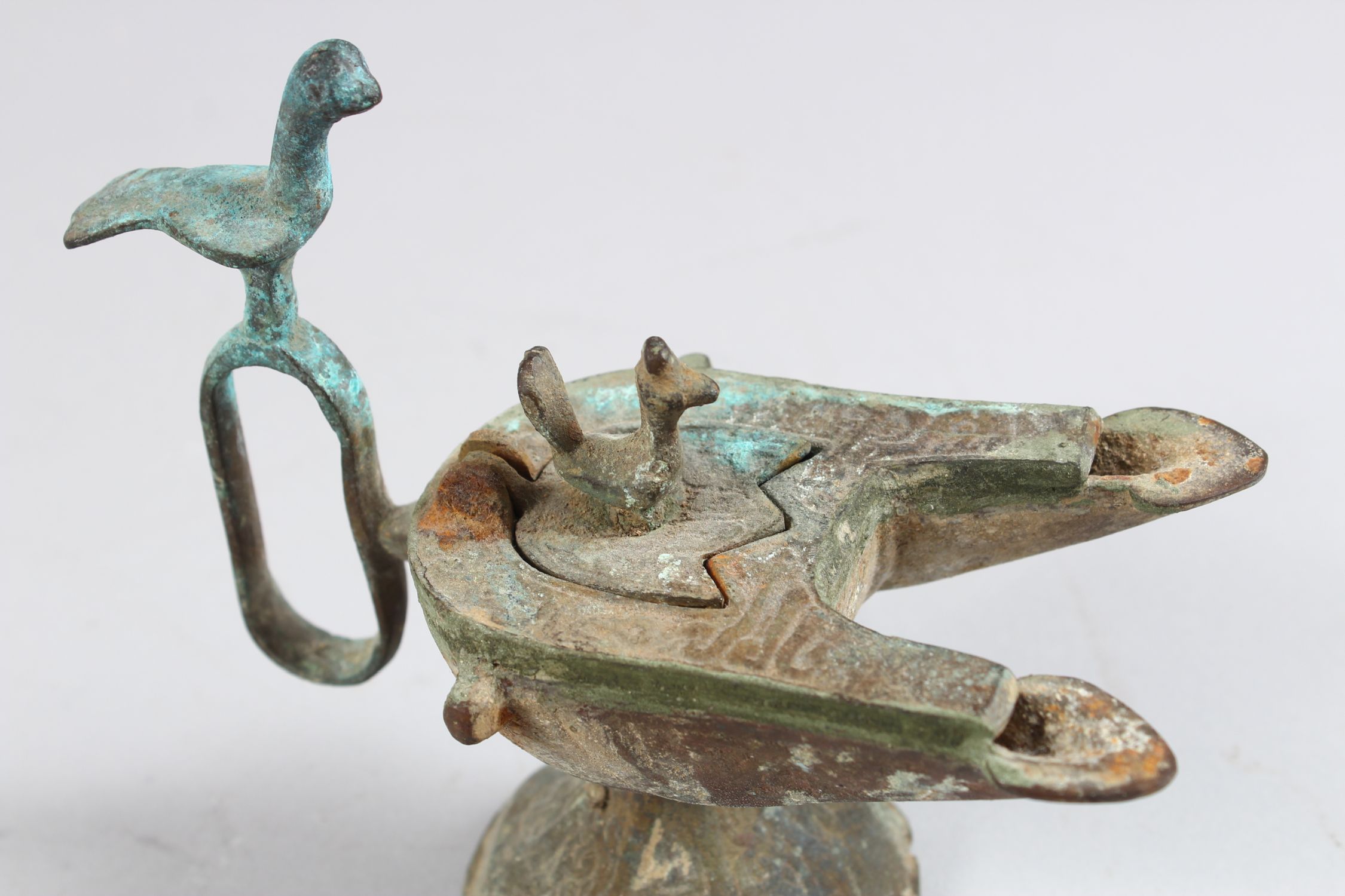 A 12TH CENTURY SELJUK BRONZE OIL LAMP with two bird finials, 12cm high. - Image 4 of 4