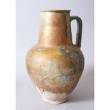 A 12TH-13TH CENTURY PERSIAN KASHAN OR SYRIAN GOLD SPLASH POTTERY EWER, 31cm high.