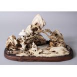 A LATE 19TH CENTURY CHINESE CARVED BONE / ANTLER FIGURE, the figure depicting a landscape scenes