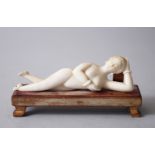 A 19TH CENTURY CHINESE CARVED IVORY ORIENTAL LADY IN NUDE & STAND, 13cm long.