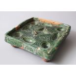 A RARE 8TH-9TH CENTURY UMMAYAD GREEN GLAZED POTTERY COSMETIC TRAY with calligraphy around the