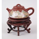 A CHINESE YIXING TEAPOT & HARDWOOD STAND, the teapot with a painted landscape scene, the reverse
