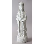 A 19TH CENTURY CHINESE BLANC DE CHINE FIGURE OF GUANYIN, stood upon a stylized wave base. 39.2cm