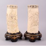 A GOOD PAIR OF JAPANESE MEIJI PERIOD CARVED IVORY TUSK VASES ON GOLD LACQUER STANDS, the vase